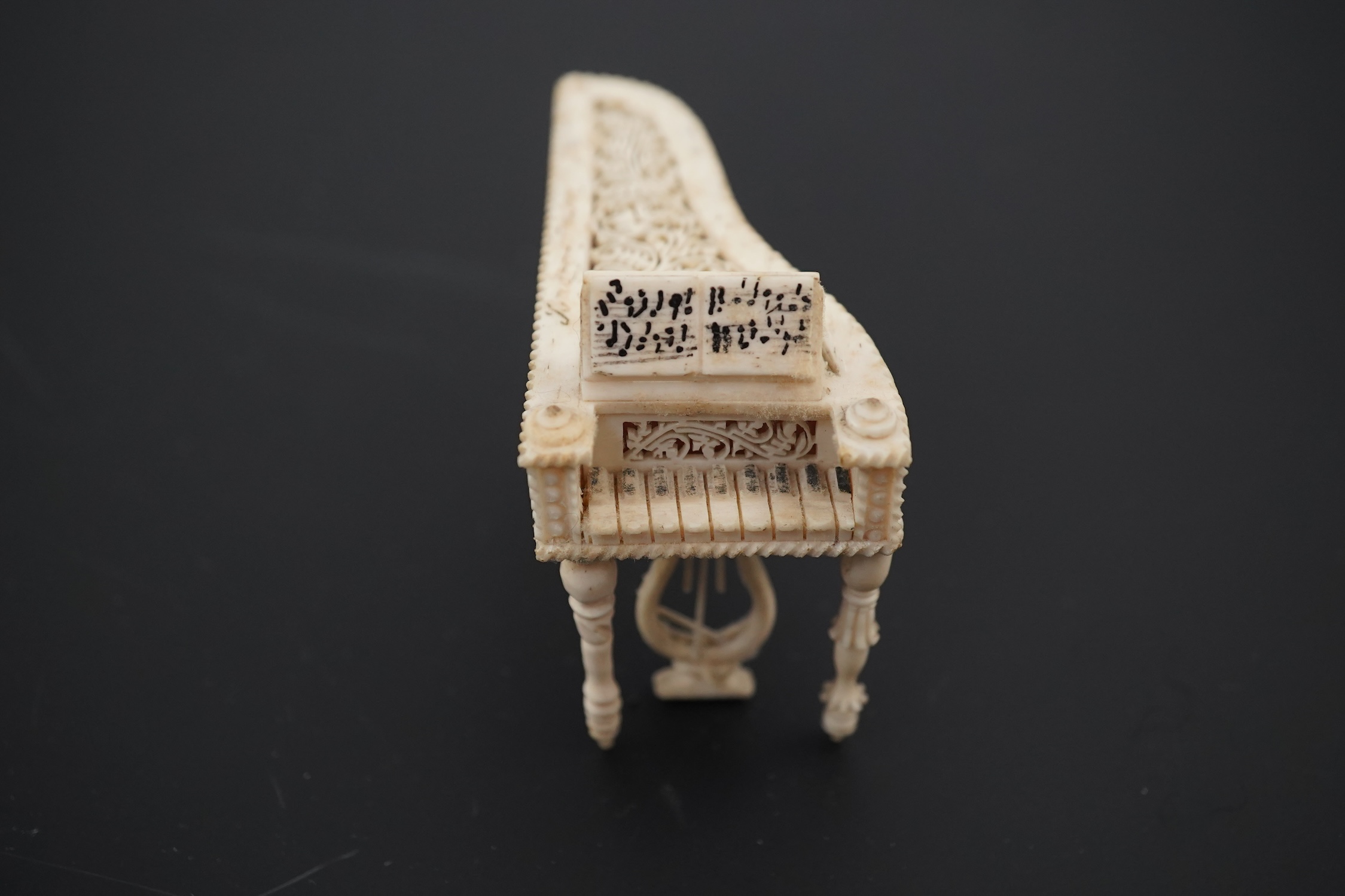 A Napoleonic Prisoner of War bone miniature model of a harpsichord, 6.5cm long. Condition - good